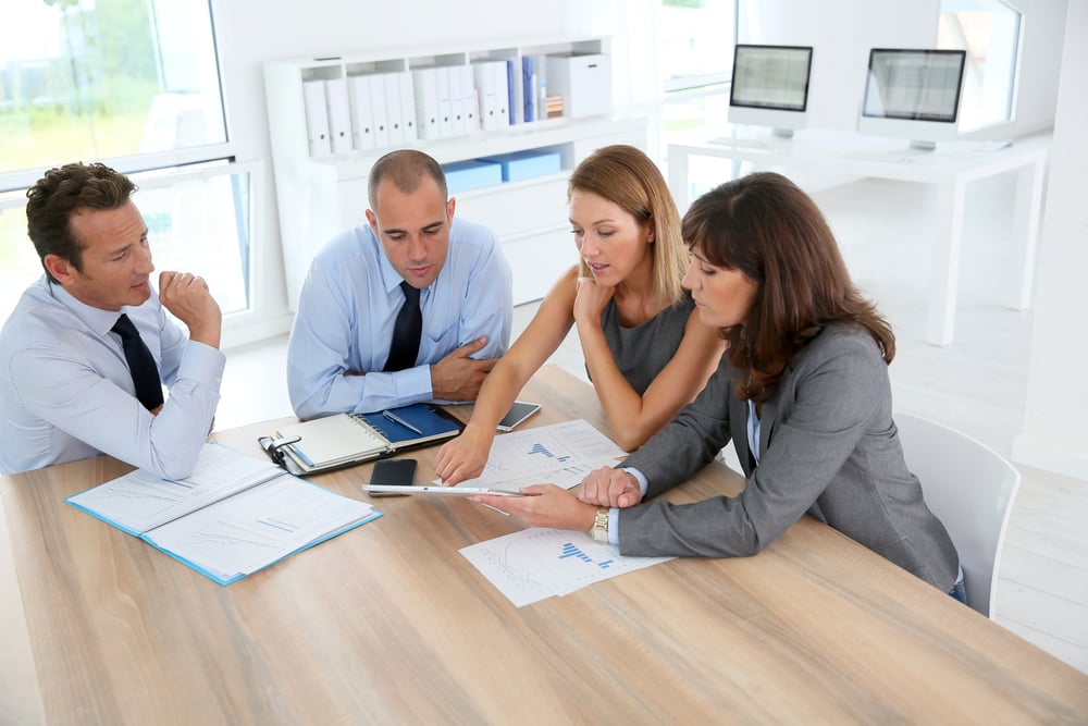 Accounting firm acquisition team meeting around table